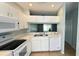 A well-lit kitchen features white cabinets, modern appliances, and a clean aesthetic, blending style and functionality at 1400 Costa Mesa Dr, Wesley Chapel, FL 33543