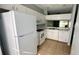 A clean, well-maintained kitchen with white appliances and cabinets, providing a functional and bright cooking space at 1400 Costa Mesa Dr, Wesley Chapel, FL 33543