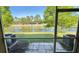 Relaxing screened patio view of a peaceful pond and well-maintained community landscaping at 1400 Costa Mesa Dr, Wesley Chapel, FL 33543