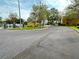 Inviting street view of well-kept yellow buildings within a secure, gated community at 1400 Costa Mesa Dr, Wesley Chapel, FL 33543