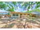 Spacious backyard with partial fencing offers potential for outdoor activities and relaxation at 1433 Spring Ln, Clearwater, FL 33755