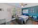 Bright bedroom with ample natural light, ceiling fan, and two windows overlooking the yard at 1433 Spring Ln, Clearwater, FL 33755