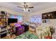 Bedroom with colorful accents, ceiling fan, and ample space for relaxation at 1433 Spring Ln, Clearwater, FL 33755