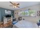 Bright bedroom with ample natural light, ceiling fan, and one window overlooking the yard at 1433 Spring Ln, Clearwater, FL 33755