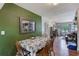 Charming dining room with wood floors, table with four chairs, and views into the living room at 1433 Spring Ln, Clearwater, FL 33755