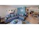 Spacious living area with blue accent wall, sectional sofa, and open layout to dining and kitchen at 1433 Spring Ln, Clearwater, FL 33755