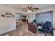 View of the living room leading into the kitchen and dining area with wood flooring at 1433 Spring Ln, Clearwater, FL 33755