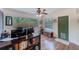 Bright living room with ceiling fan, wood floors, and natural light streaming through the windows at 1433 Spring Ln, Clearwater, FL 33755