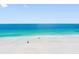 Aerial view of the beach, showing pristine sands and clear, azure waters at 1480 Gulf Blvd # 1004, Clearwater Beach, FL 33767
