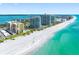 Aerial view showcasing beachfront condos with pristine white sands and turquoise waters at 1480 Gulf Blvd # 1004, Clearwater Beach, FL 33767