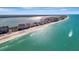 Expansive aerial view of condos lining the shoreline with the ocean on one side and bay on the other at 1480 Gulf Blvd # 1004, Clearwater Beach, FL 33767
