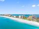 Stunning aerial of beachfront condos with turquoise water and white sand beach under blue sky at 1480 Gulf Blvd # 1004, Clearwater Beach, FL 33767
