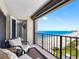 Relax on the balcony with seating and stunning views of the white sand beach and ocean at 1480 Gulf Blvd # 1004, Clearwater Beach, FL 33767