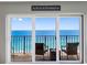 Balcony view of the ocean with patio furniture and sliding glass doors at 1480 Gulf Blvd # 1004, Clearwater Beach, FL 33767