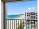 Scenic balcony view overlooking the sandy beach, pool, and ocean beyond at 1480 Gulf Blvd # 1004, Clearwater Beach, FL 33767