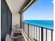 Charming balcony featuring stylish seating and stunning views of the turquoise ocean at 1480 Gulf Blvd # 1004, Clearwater Beach, FL 33767