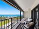 Charming balcony with plush seating, city, and water views, perfect for relaxation at 1480 Gulf Blvd # 1004, Clearwater Beach, FL 33767