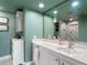 Elegant bathroom with a sleek countertop, cabinet, and large mirror with great lighting at 1480 Gulf Blvd # 1004, Clearwater Beach, FL 33767