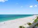Expansive beach view showcasing soft, white sand meeting the serene blue ocean waters at 1480 Gulf Blvd # 1004, Clearwater Beach, FL 33767