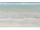 Calm ocean waves lapping onto a sandy beach at 1480 Gulf Blvd # 1004, Clearwater Beach, FL 33767