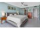 Comfortable bedroom featuring a queen bed with a white comforter, tiled floors and a ceiling fan at 1480 Gulf Blvd # 1004, Clearwater Beach, FL 33767