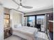Bedroom with a queen bed and balcony access, offering beautiful views of the beach and clear skies at 1480 Gulf Blvd # 1004, Clearwater Beach, FL 33767