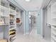 Walk-in closet with custom shelving to maximize storage and organization of clothing and shoes at 1480 Gulf Blvd # 1004, Clearwater Beach, FL 33767