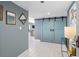 Hallway featuring elegant mirrors, white tile floors, and sliding barn doors to living area at 1480 Gulf Blvd # 1004, Clearwater Beach, FL 33767
