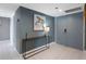 Hallway showing decorative turtle art, modern table lamp, sleek console table and access to bedroom at 1480 Gulf Blvd # 1004, Clearwater Beach, FL 33767