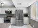Modern kitchen with stainless steel appliances, white cabinets, and ocean views at 1480 Gulf Blvd # 1004, Clearwater Beach, FL 33767