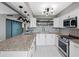Modern kitchen with stainless appliances, granite countertops and white cabinets at 1480 Gulf Blvd # 1004, Clearwater Beach, FL 33767