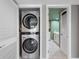 Convenient stacked washer and dryer with adjacent bathroom area at 1480 Gulf Blvd # 1004, Clearwater Beach, FL 33767