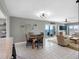 Bright open living space with dining area, tile floors, and ocean views from the large balcony at 1480 Gulf Blvd # 1004, Clearwater Beach, FL 33767