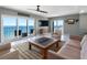 Open living space with water views, a large television, and modern furnishings at 1480 Gulf Blvd # 1004, Clearwater Beach, FL 33767