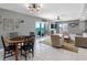Living area with tiled floors, dining area, balcony access, and comfortable seating at 1480 Gulf Blvd # 1004, Clearwater Beach, FL 33767