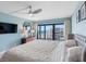 Beautiful main bedroom with a large bed, TV, dresser, and balcony access with ocean views at 1480 Gulf Blvd # 1004, Clearwater Beach, FL 33767