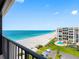 Beautiful ocean view from a high-rise balcony showing the beach, palm trees, and blue water at 1480 Gulf Blvd # 1004, Clearwater Beach, FL 33767