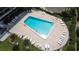 Aerial view of refreshing pool surrounded by lounge chairs and landscaped grounds at 1480 Gulf Blvd # 1004, Clearwater Beach, FL 33767