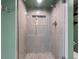 Modern tiled shower with pebble floor and recessed storage niche at 1480 Gulf Blvd # 1004, Clearwater Beach, FL 33767