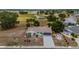 Aerial view of property and mature trees; pond in the distance at 1509 Cherry Hills Dr, Sun City Center, FL 33573