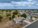 Aerial view of property and community; pond and mature trees in view at 1509 Cherry Hills Dr, Sun City Center, FL 33573