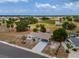 Aerial view of a single-story home with a long driveway and mature trees at 1509 Cherry Hills Dr, Sun City Center, FL 33573