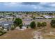 A high angle shot of a house in a neighborhood with palm trees and a glimpse of a nearby lake at 1509 Cherry Hills Dr, Sun City Center, FL 33573