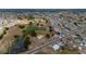 An aerial view of a home in a community with ponds and green spaces, showcasing its location at 1509 Cherry Hills Dr, Sun City Center, FL 33573