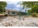 View of backyard with green chain link fence and covered patio at 1509 Cherry Hills Dr, Sun City Center, FL 33573