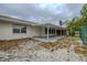 Covered patio extending to the yard with privacy fence; palm trees in view at 1509 Cherry Hills Dr, Sun City Center, FL 33573