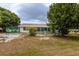 Wide backyard with green chain link fence and view of enclosed patio at 1509 Cherry Hills Dr, Sun City Center, FL 33573