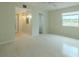 Spacious bedroom with view of hallway and ceiling fan at 1509 Cherry Hills Dr, Sun City Center, FL 33573