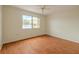 Bright bedroom with wood floors and a large window overlooking the yard at 1509 Cherry Hills Dr, Sun City Center, FL 33573