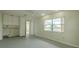 Bonus room with neutral walls, vinyl flooring, a window, and rear door at 1509 Cherry Hills Dr, Sun City Center, FL 33573